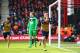 BOURNEMOUTH, ENGLAND - FEBRUARY 07: Goalkeeper Artur Boruc of Bournemouth looks dejected as Mesut Ozil of Arsenal celebrates as he scores their first goal during the Barclays Premier League match between A.F.C. Bournemouth and Arsenal at the Vitality Sta