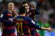 Barcelona's Argentinian forward Lionel Messi celebrates with teammate Brazilian defender Adriano after scoring a goal during the Spanish league football match Real Sporting de Gijon vs FC Barcelona at El Molinon stadium in Gijon on February 17, 2016. AFP