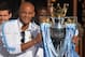 Manchester City's Belgian defender Vincent Kompany holds the Premiership trophy as Manchester City football club players prepare to take part in a victory parade on an open-topped bus through the streets of Manchester, northwest England, on May 12, 2014,