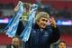 LONDON, ENGLAND - MARCH 02: Manuel Pellegrini, manager of Manchester City celebrates victory with the trophy after the Capital One Cup Final between Manchester City and Sunderland at Wembley Stadium on March 2, 2014 in London, England. (Photo by Michael