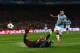 BARCELONA, SPAIN - MARCH 18: Sergio Aguero of Manchester City is challenged by Gerard Pique and Javier Mascherano of Barcelona as he shoots at goal during the UEFA Champions League Round of 16 second leg match between Barcelona and Manchester City at Cam