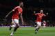 Manchester United's English striker Marcus Rashford (L) celebrates scoring his team's third goal with Manchester United's Spanish midfielder Juan Mata during the UEFA Europa League round of 32, second leg football match between Manchester United and and F