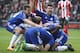 Chelsea's Brazilian-born Spanish striker Diego Costa (R top) and Chelsea's Spanish defender Cesar Azpilicueta (top L) join the celebration after Chelsea's Serbian defender Branislav Ivanovic (C floor obscured) scored their second goal during the English P