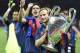 Barcelona's Croatian midfielder Ivan Rakitic celebrates with the trophy after winning the UEFA Champions League Final football match between Juventus and FC Barcelona at the Olympic Stadium in Berlin on June 6, 2015. AFP PHOTO / LLUIS GENE