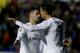Real Madrid's midfielder Isco (L) celebrates a goal with Real Madrid's Portuguese forward Cristiano Ronaldo during the Spanish league football match Levante UD vs Real Madrid CF at the Ciutat de Valencia stadium in Valencia on March 2, 2016. / AFP / Jose