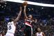 Mar 4, 2016; Toronto, Ontario, CAN; Portland Trail Blazers guard Damian Lillard (0) scores a basket on a shot over Toronto Raptors center Bismack Biyombo (8) at Air Canada Centre. The Raptors beat the Trail Blazers 117-115. Mandatory Credit: Tom Szczerbow