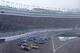 The field enters Turn 1 as a sandstorm descends.