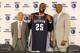 CHARLOTTE, NC - JULY 10: Al Jefferson #25 of the Charlotte Bobcats poses with his uniform alongside General Manager Rich Cho and President of Basketball Operations Rod Higgins during his intro to the media at the Time Warner Cable Arena on July 10, 2013