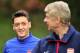 Arsenal's German midfielder Mesut Ozil (L) and French manager Arsene Wenger (R) speak during a team training session for the forthcoming UEFA Champions League Group F football match against SSC Napoli at Arsenal's London Colney training ground in north Lo