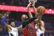 Mar 26, 2016; Orlando, FL, USA; Chicago Bulls forward Taj Gibson (22) goes up for the shot against Orlando Magic forward Aaron Gordon (00) and guard Elfrid Payton (left) during the first quarter of a basketball game at Amway Center. Mandatory Credit: Rein