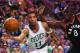 BOSTON, MA - MARCH 23: Evan Turner #11 of the Boston Celtics saves a rebound from going out of bounds with pressure from Bismack Biyombo #8 of the Toronto Raptors during the first quarter at TD Garden on March 23, 2016 in Boston, Massachusetts. (Photo b
