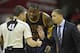 Mar 23, 2016; Cleveland, OH, USA; Cleveland Cavaliers forward LeBron James (23) and head coach Tyronn Lue talk with referee Scott Foster (48) in the fourth quarter at Quicken Loans Arena. Mandatory Credit: David Richard-USA TODAY Sports