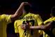 Villarreal's French forward Cedric Bakambu celebrates with teammates after scoring during the Spanish league football match Sevilla FC vs Villarreal CF at the Ramon Sanchez Pizjuan stadium in Sevilla on March 13, 2016. / AFP / JORGE GUERRERO (Photo