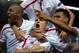 TOPSHOT - Sevilla's French forward Kevin Gameiro (C) celebrates with his teammates their victory at the end of the UEFA Europa League quarter finals second leg football match Sevilla FC vs Athletic Club Bilbao at the Ramon Sanchez Pizjuan stadium in Sevil