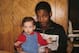 Rod Strickland with Steve Smith's infant son in 1985.