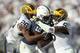 Nov 21, 2015; University Park, PA, USA; Penn State Nittany Lions wide receiver Chris Godwin (12) runs with the ball as Michigan Wolverines cornerback Jourdan Lewis (26) and safety Jabrill Peppers (5) attempt to tackle during the third quarter at Beaver St