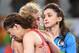 Japanese wrestling legend Saori Yoshida (front) embraces her vanquisher, Helen Maroulis, after their championship bout.