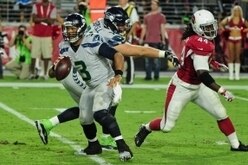 Oct 23, 2016; Glendale, AZ, USA; Seattle Seahawks quarterback Russell Wilson (3) runs from Arizona Cardinals outside linebacker Markus Golden (44) as offensive tackle Bradley Sowell (78) defends during the second half at University of Phoenix Stadium. Man
