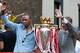 LONDON, UNITED KINGDOM: Arsenal team captain Patrick Vieira (L) and manager Arsene Wenger wave from the open-top bus carrying the winners of the British Premier League Championship, Arsenal players and their families, on its way to Islington Town Hall,1