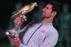 Novak Djokovic eyes his trophy after winning the Qatar Open in Doha.