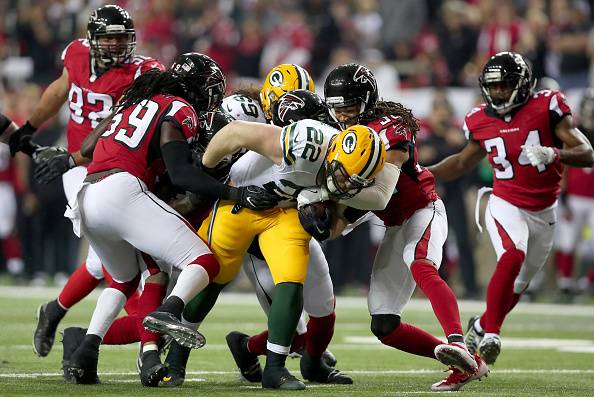ATLANTA, GA - JANUARY 22:  Aaron Ripkowski #22 of the Green Bay Packers fumbles the ball in the second quarter after contact with Jalen Collins #32 of the Atlanta Falcons in the NFC Championship Game at the Georgia Dome on January 22, 2017 in Atlanta, Geo