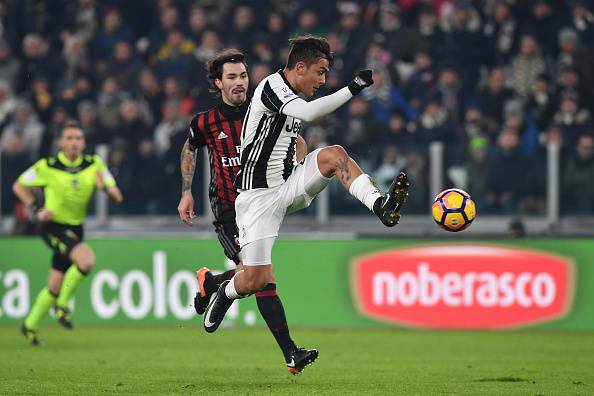 TURIN, ITALY - JANUARY 25:  Paulo Dybala (R) of Juventus FC controls the ball against Alessio Romagnoli of AC Milan during the TIM Cup match between Juventus FC and AC Milan at Juventus Stadium on January 25, 2017 in Turin, Italy.  (Photo by Valerio Penni