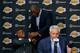 Magic Johnson welcomes Byron Scott as Mitch Kupchak addresses the media.