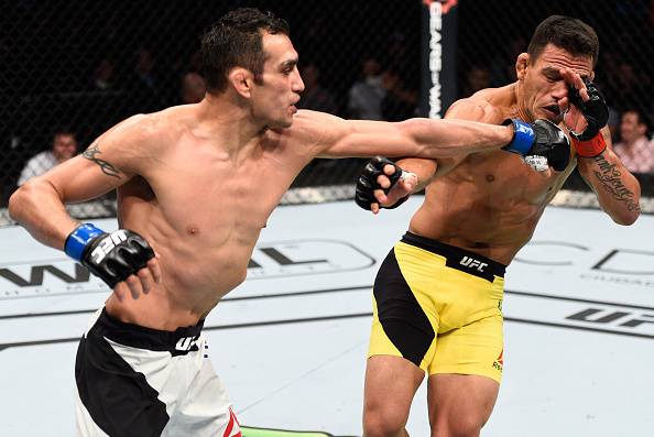 MEXICO CITY, MEXICO - NOVEMBER 05: (L-R) Tony Ferguson of the United States punches Rafael Dos Anjos of Brazil in their lightweight bout during the UFC Fight Night event at Arena Ciudad de Mexico on November 5, 2016 in Mexico City, Mexico. (Photo by Jeff
