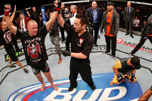 St-Pierre put his gloves on the mantel alongside the UFC title.