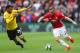 WATFORD, ENGLAND - SEPTEMBER 18: Luke Shaw of Manchester United (R) takes the ball past Etienne Capoue of Watford (L) during the Premier League match between Watford and Manchester United at Vicarage Road on September 18, 2016 in Watford, England. (Phot