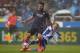LA CORUNA, SPAIN - MARCH 12: Alex Bergantinos of RC Deportivo La Coruna competes for the ball with Arda Turan of FC Barcelona during the La Liga match between RC Deportivo La Coruna and FC Barcelona at Riazor Stadium on March 12, 2017 in La Coruna, Spain.