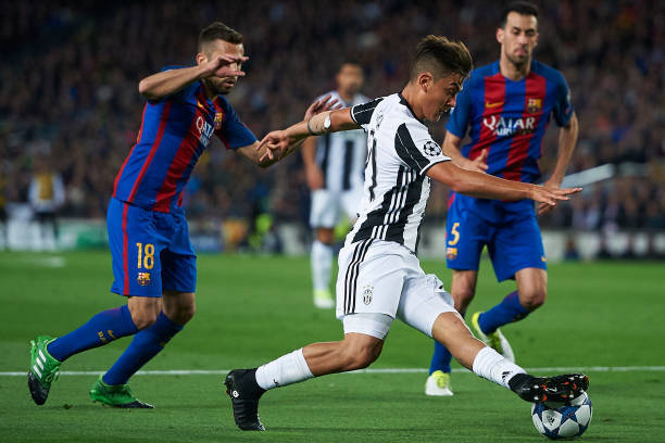 BARCELONA, SPAIN - APRIL 19: Jordi Alba (L) of Barcelona competes for the ball with Paulo Dybala of Juventus during the UEFA Champions League Quarter Final second leg match between FC Barcelona and Juventus at Camp Nou on April 19, 2017 in Barcelona, Spa