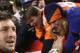 DENVER, CO - JANUARY 08: Quarterback Tim Tebow #15 of the Denver Broncos receives high fives from fans after defeating the Pittsburgh Steelers in overtime of the AFC Wild Card Playoff game at Sports Authority Field at Mile High on January 8, 2012 in Denver, Colorado. The Broncos defeated the Steelers in overtime 23-29. (Photo by Jeff Gross/Getty Images)