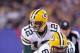 EAST RUTHERFORD, NJ - DECEMBER 04: Aaron Rodgers #12 of the Green Bay Packers calls signals out as he stands at the line of scrimmage behind center Scott Wells #63 of the Green Bay Packers against the New York Giants at MetLife Stadium on December 4, 2011 in East Rutherford, New Jersey. The Packers won 38-35. (Photo by Nick Laham/Getty Images)