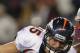 FOXBORO, MA - JANUARY 14: Tim Tebow #15 of the Denver Broncos runs with the ball against Mark Anderson #95 and Brandon Deaderick #71 of the New England Patriots during their AFC Divisional Playoff Game at Gillette Stadium on January 14, 2012 in Foxboro, Massachusetts. (Photo by Jim Rogash/Getty Images)