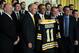 WASHINGTON, DC - JANUARY 23: U.S. President Barack Obama (3rd L) poses for photos with members of the Boston Bruins (first row, L-R) head coach Claude Julien, team owner Jeremy Jacobs, Jacobs' son Charlie, team president of Cam Neely and assistant general manager Jim Benning after he was presented with a jersey by during a East Room event at the White House January 23, 2012 in Washington, DC. The six-time Stanley Cup champions were honored by the President for winning the 2011 Stanley Cup last June. (Photo by Alex Wong/Getty Images)