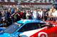 Crowds surround a Daytona Prototype on pit road just before the start of the Rolex 24