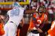 BLACKSBURG, VA - NOVEMBER 17: Logan Thomas #3 of the Virginia Tech Hokies is struck in the head after throwing the ball by Quinton Coples #90 of the North Carolina Tar Heels at Lane Stadium on November 17, 2011 in Blacksburg, Virginia. (Photo by Geoff Burke/Getty Images)
