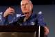 Tom Coughlin with hand locked in coin-flip grip from analyzing the art for hours on end since winning the NFC championship.