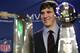 INDIANAPOLIS, IN - FEBRUARY 06: In this General Motors handout, Eli Manning #10 of the New York Giants poses with the Super Bowl Championship Lombardi Trophy (right) and the Pete Rozelle Trophy for being the Super Bowl XLVI Most Valuable Player after defeating the New England Patriots during Super Bowl XLVI on February 6, 2012 in Indianapolis, Indiana. Manning, named MVP, led the Giants to a 21-17 victory. (Photo by AJ Mast/General Motors via Getty Images)