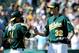 OAKLAND, CA - SEPTEMBER 03: Kurt Suzuki #8 and Brandon McCarthy #32 of the Oakland Athletics celebrate defeating the Seattle Mariners 3 to 0 during an MLB baseball game at O.co Coliseum on September 3, 2011 in Oakland, California. (Photo by Thearon W. Henderson/Getty Images)
