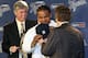 DETROIT, MI - JANUARY 26: Prince Fielder #28 of the Detroit Tigers puts on his jersey, helped by CEO and general manager Dave Dombrowski (L) and owner Mike Ilitch during a press conference at Comerica Park on January 26, 2012 in Detroit, Michigan. (Photo by Jorge Lemus/Getty Images)