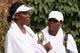 WIMBLEDON, ENGLAND - JUNE 18: Venus Williams (L) and Serena Williams conclude their training session on the Aorangi Practice court at the All England Lawn Tennis and Croquet Club ahead of the Wimbledon Lawn Tennis Championships on June 18, 2011 in London, England. The Championships, which are celebrating their 125th anniversary this year, begin on June 20. (Photo by Oli Scarff/Getty Images)