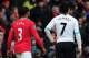 MANCHESTER, ENGLAND - FEBRUARY 11: Patrice Evra of Manchester United walks with Luis Suarez of Liverpool during the Barclays Premier League match between Manchester United and Liverpool at Old Trafford on February 11, 2012 in Manchester, England. (Photo by Shaun Botterill/Getty Images)