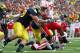 ANN ARBOR, MI - NOVEMBER 19: Ameer Abdullah #8 of the Nebraska Cornhuskers takes a hit from Mike Martin #68 of the Michigan Wolverines during a third quarter run at Michigan Stadium on November 19, 2011 in Ann Arbor, Michigan. Michigan won the game 45-17. (Photo by Gregory Shamus/Getty Images)