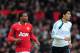 MANCHESTER, ENGLAND - FEBRUARY 11: Patrice Evra of Manchester United jogs with Luis Suarez of Liverpool during the Barclays Premier League match between Manchester United and Liverpool at Old Trafford on February 11, 2012 in Manchester, England. (Photo by Shaun Botterill/Getty Images)