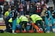 Worried Gunners look on as Mertesacker is attended to by the medical crew at Sunderland.