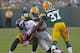 GREEN BAY, WI - OCTOBER 2: Knowshon Moreno #27 of the Denver Broncos gets hit by C.J. Wilson #98 and Sam Shields #37 of the Green Bay Packers at Lambeau Field on October 2, 2011 in Green Bay, Wisconsin. (Photo by Matt Ludtke /Getty Images)
