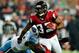 ATLANTA, GA - NOVEMBER 20: Michael Turner #33 of the Atlanta Falcons breaks away from Malcolm Sheppard #96 of the Tennessee Titans during play at the Georgia Dome on November 20, 2011 in Atlanta, Georgia. (Photo by Grant Halverson/Getty Images)