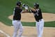 CHICAGO, IL - JULY 26: Adam Dunn #32 of the Chicago White Sox (L) is greeted by teammate Paul Konerko #14 after hitting a two-run home run in the 1st inning against the Detroit Tigers at U.S. Cellular Field on July 26, 2011 in Chicago, Illinois. (Photo by Jonathan Daniel/Getty Images)